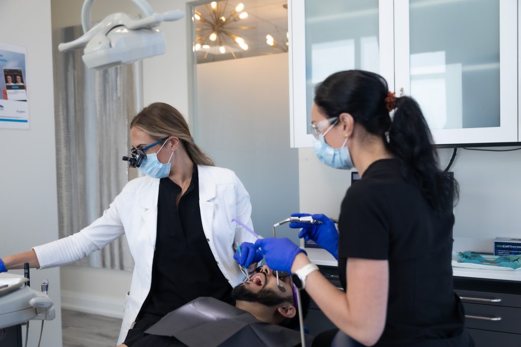 One of our dentists and hygienists working with a patient.